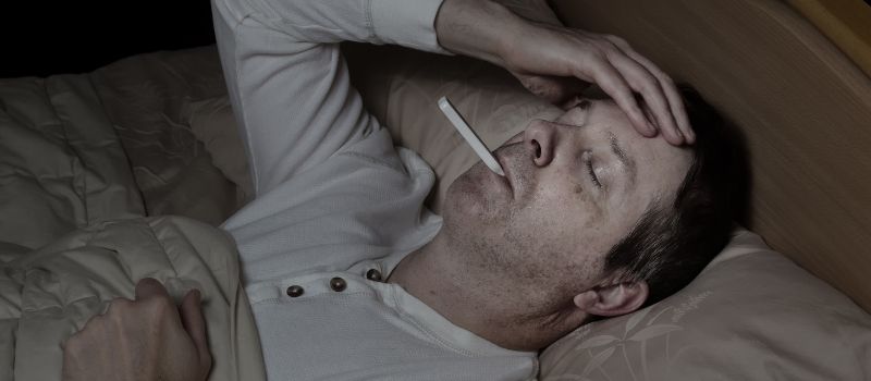 man with thermometer suffering from cotton fever