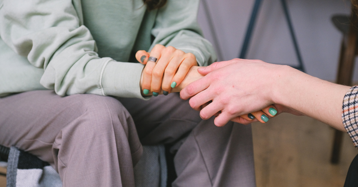 A woman receiving support from a friend