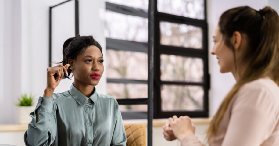 Woman asking HR representative if she can get fired for going to rehab