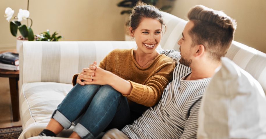 A man and a woman sitting on a couch discussing their healthy boundaries in their relationship